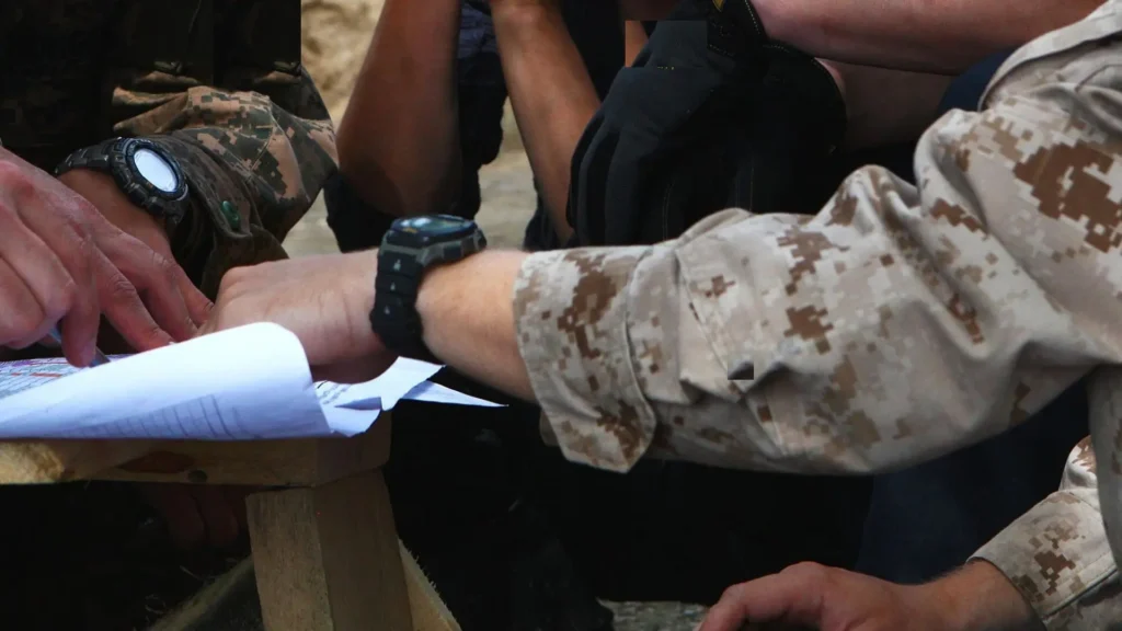Hands reviewing construction plans on a job site