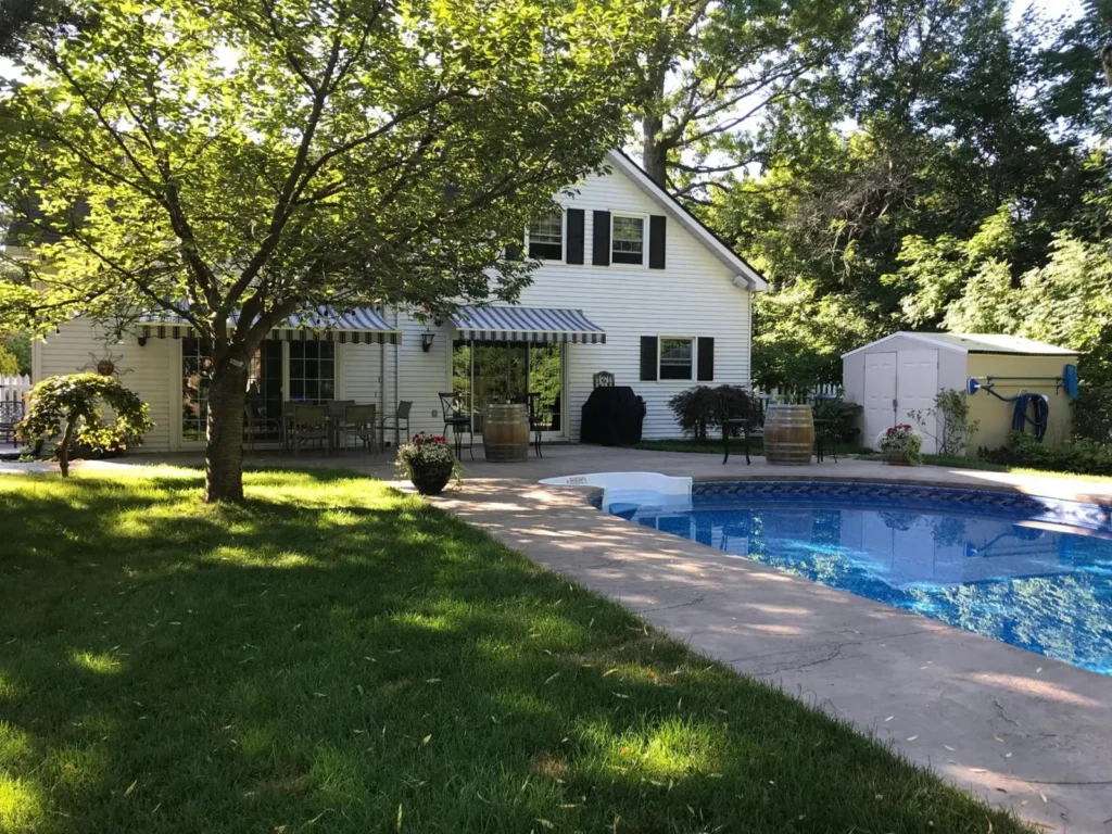 Backyard with a swimming pool, patio and detached shed beside the main house