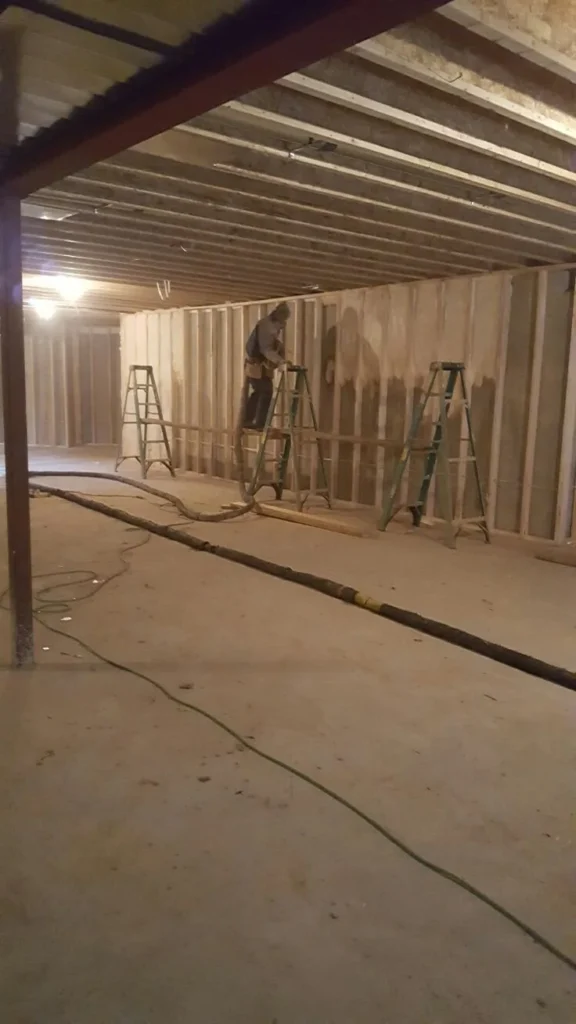 Crew framing a long basement wall under a steel beam, Westboro, Ottawa